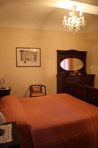 a bedroom with a bed and a chandelier at Cà Veja in Montà