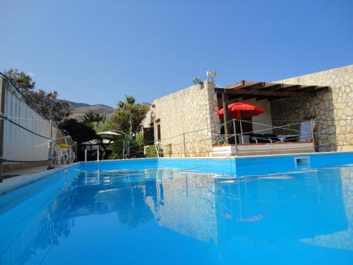 una piscina con acqua blu di fronte a un edificio di Ai Tre Scalini a Valderice