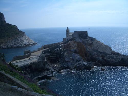 a castle on top of a rocky island in the water at A House In Tuscany in Bagnone