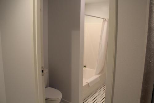 a bathroom with a toilet and a bath tub at The Inn on the River in Donaldsonville
