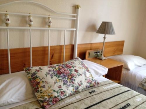 a bedroom with two beds and a pillow on a bed at Georgian Court B&B Guest House in Melbourne