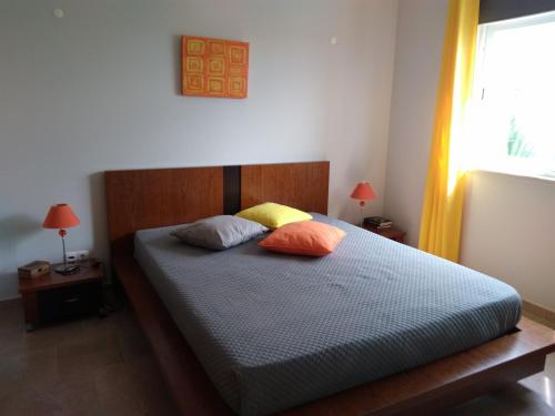 a bedroom with a bed with two pillows on it at Villa Casa do Monte in Silves