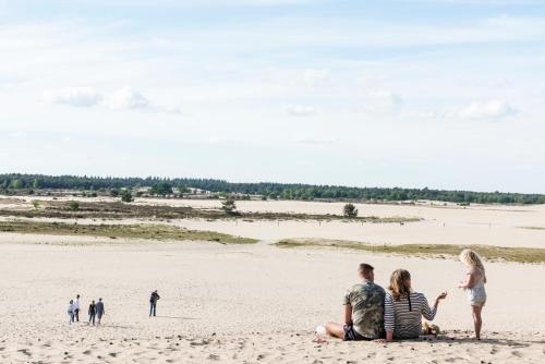a group of people sitting on a beach at Hotel De Kruishoeve 's-Hertogenbosch - Vught in Vught