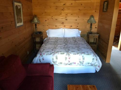 a bedroom with a bed and a couch at Winthrop Mountain View Chalets in Winthrop