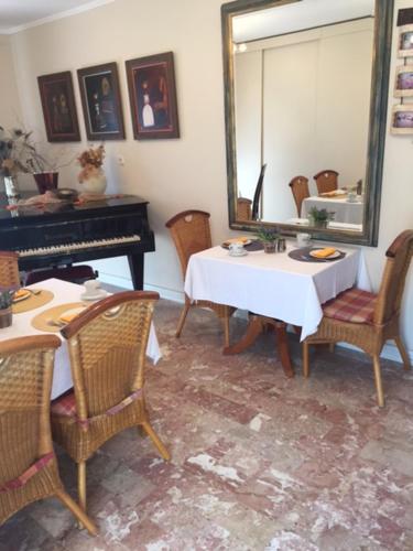 a room with a table and a mirror and a piano at Villa Bougenvilia Tomas in Tučepi