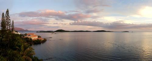 a view of a large body of water at sunset at Le Stanley Hôtel in Noumea