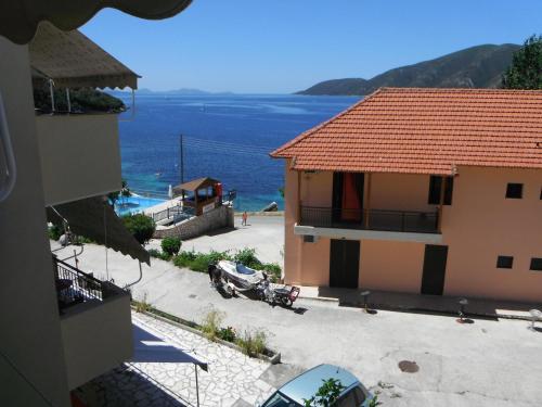 a car parked in a parking lot next to a house at Dimitris Apartments in Vasiliki