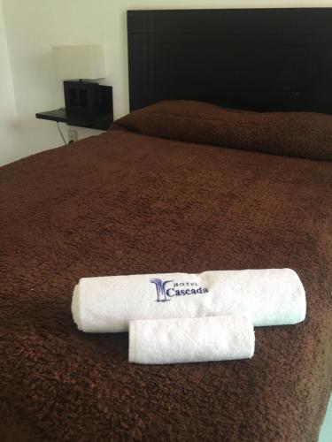 a hotel room with a towel on a bed at Hotel Cascada in Cuautla Morelos
