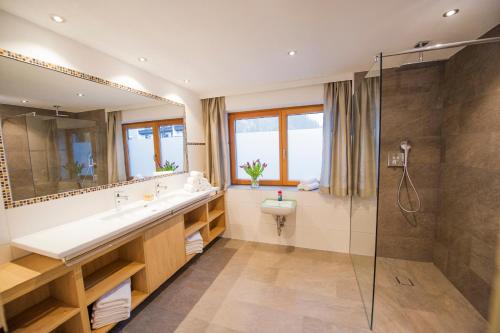 a bathroom with a sink and a shower at Chalet & Apartments Tiroler Bua in Achenkirch