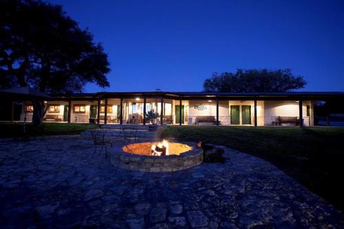 a building with a fire pit in front of it at Joshua Creek Ranch in Boerne
