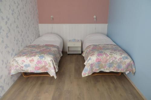 two beds sitting next to each other in a room at Arens rent Kohtu 2A Apartment in Kuressaare
