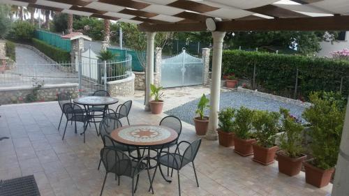 a patio with tables and chairs under a pergola at Santa Maria in Cittadella del Capo