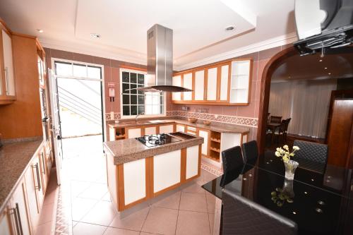 a kitchen with a stove and a counter top at Villa Santana in Funchal