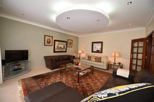a living room with a couch and a table at Villa Santana in Funchal