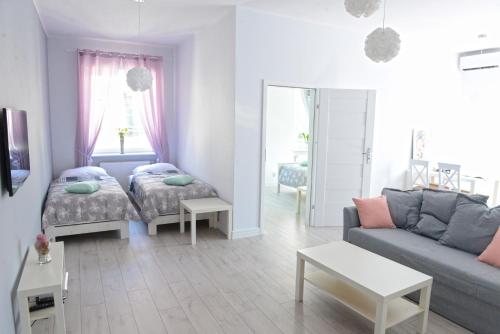 Posteľ alebo postele v izbe v ubytovaní Apartamenty Zamkowa
