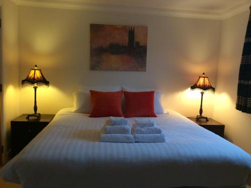 a bedroom with a large white bed with two lamps at The Botanic Hub West End - 2 Bedrooms in Glasgow