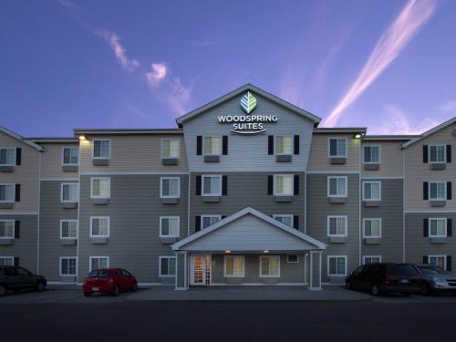 a large building with a sign on top of it at WoodSpring Suites Junction City in Junction City