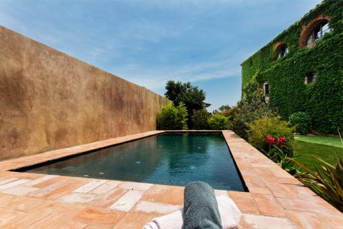 a person standing in front of a swimming pool at Encís d'Empordà -Adults Only- in Casavells