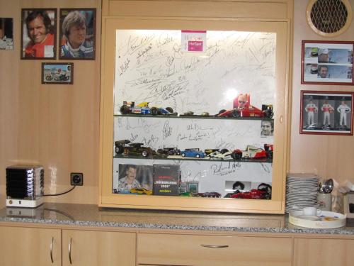 a glass display case with toys in it at Hotel zur Burg Nürburg in Nürburg
