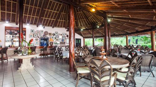 a restaurant with tables and chairs in a room at Aore Island Resort in Luganville