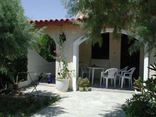 a patio with a table and chairs on a house at Irene Villa in Ierápetra
