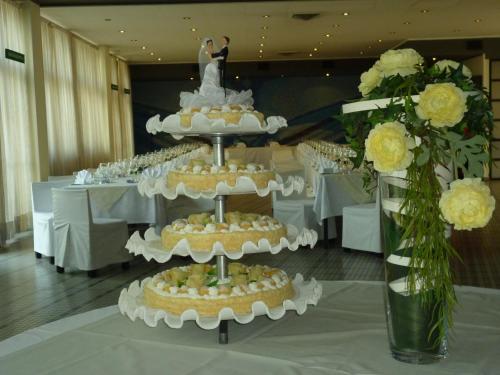 a wedding cake with a bride and groom on top at Grand Hotel President in Spilimbergo