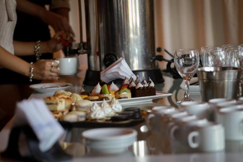 a table with a plate of food and wine glasses at Hotel Dos Venados in San Luis