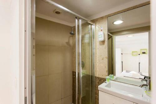 a bathroom with a shower and a sink and a mirror at Alfama T1 Travel in Lisbon