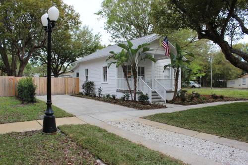 a white house with an american flag in front of it at The Shed in Sanford