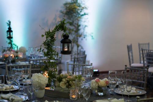 a table with glasses and flowers on it at W&P Santo Domingo in Santo Domingo