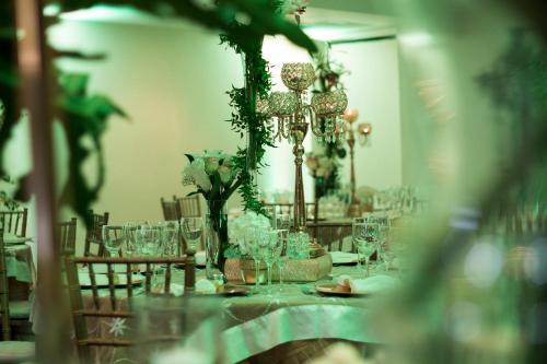 a long table with glasses and a lamp and flowers at W&P Santo Domingo in Santo Domingo