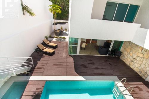 an external view of a house with a swimming pool at Casa Gem B&B in Playa del Carmen