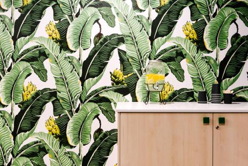 a mask sitting on top of a cabinet next to bananas at Veriu Randwick in Sydney