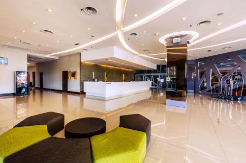 a lobby with two tables and a counter in a building at Ixora Hotel Penang in Perai