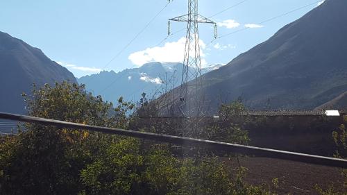 a view of a mountain with a transmission tower at Tambo de Ollantay Hotel in Ollantaytambo