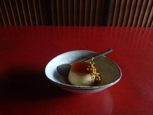 a bowl of dessert on a red table at Oyamanoyado Michitsuji in Otoyocho