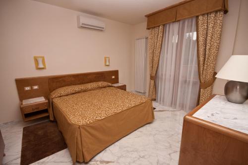Habitación de hotel con cama y ventana en Antella Residence, en Bagno a Ripoli