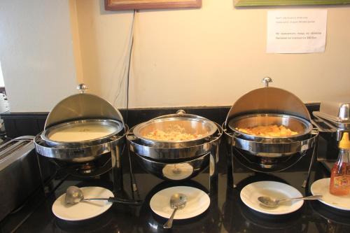 a group of three pots of food on a counter at Must Sea Hotel - SHA Hotel in Kata Beach