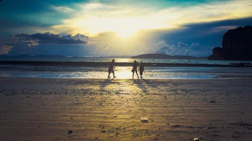 two people walking on the beach at sunset at Railay Bay Resort & Spa in Railay Beach