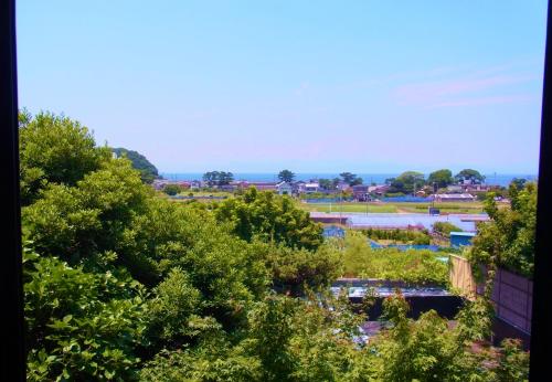 an overhead view of a park with trees and water at Omoideno Jinde in Izu
