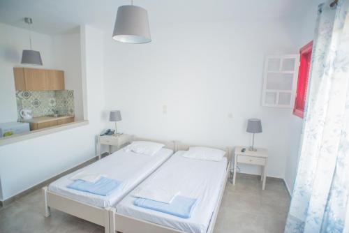 a hospital room with two beds and a window at Ostria Hotel & Apartments in Gavrio