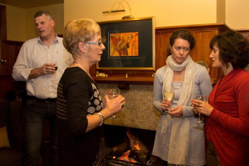 a group of people standing in a room with wine glasses at Cheltenham House in Hanmer Springs