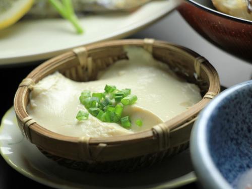a bowl of dip with green onions on top of it at Oze Shinkousou in Katashina