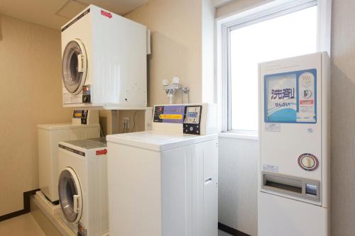 a laundry room with a washing machine and a window at Hotel Sardonyx Tokyo in Tokyo
