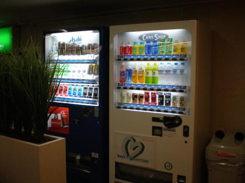 two vending machines with drinks and drinks in them at Takasaki Ekimae Plaza Hotel in Takasaki