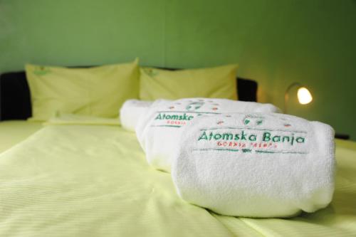 a pile of towels sitting on top of a bed at Clinic for Rehabilitation Vujan in Čačak
