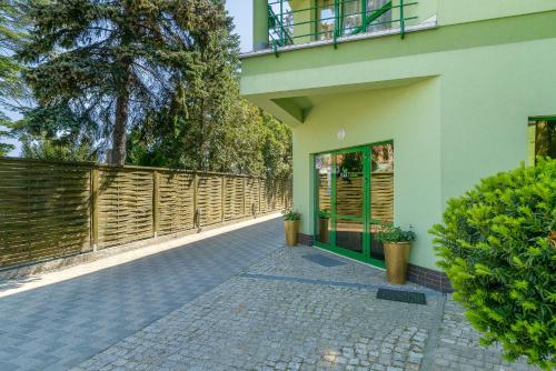 a building with a walkway next to a fence at Hotel Zielony in Poznań