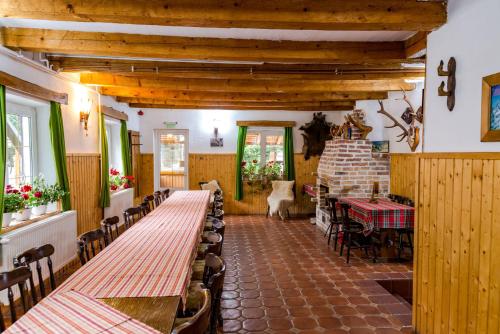 a dining room with a long table and chairs at Cabana Groapa Seaca in Petroşani