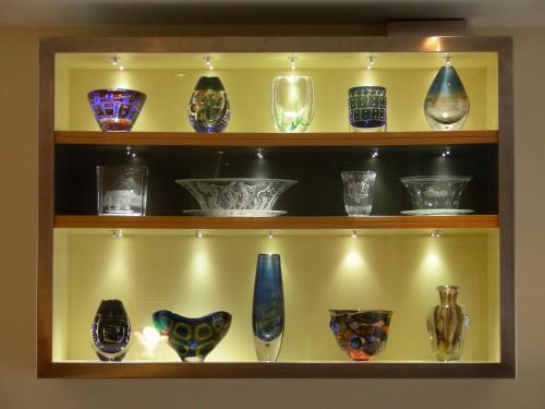 a shelf filled with different types of glass vases at Best Western Hotel Royal in Malmö