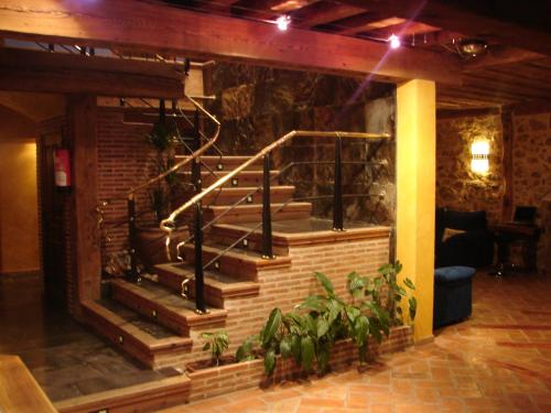 a set of stairs in a room with plants at Posada Los Templarios in Ucero
